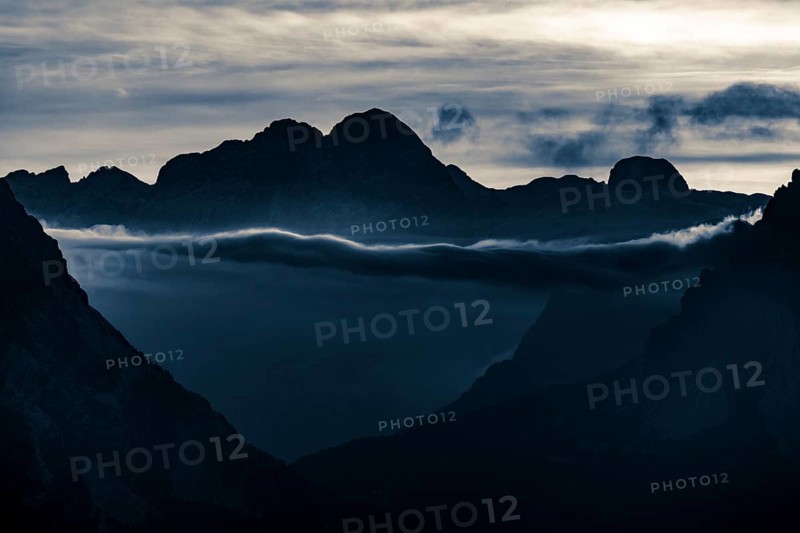 Mountain top of the Dolomites with dramatic cloudy sky