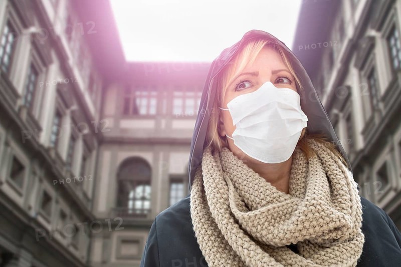 Young Woman Wearing Face Mask Walks Near the Uffizi Gallery