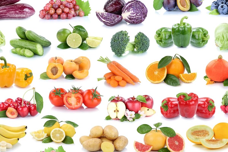 Fruit and vegetables fruits background apple tomatoes lemons oranges berries salad collage cropped against a white background