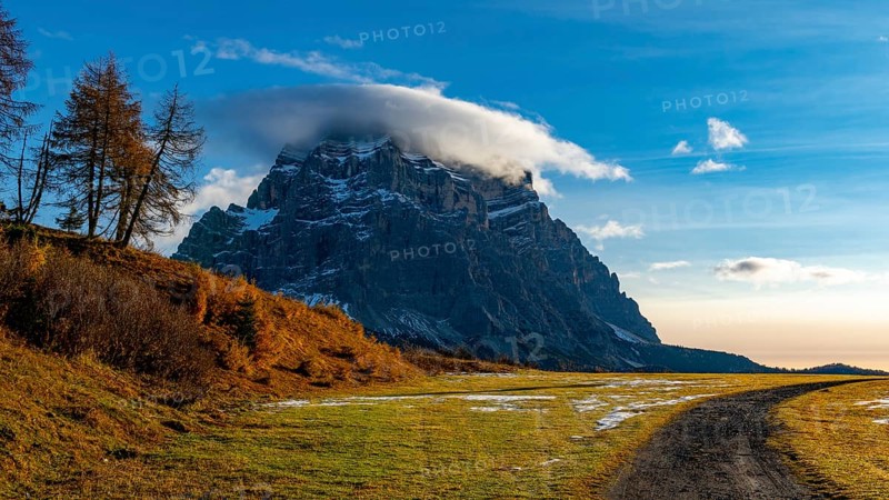 Peak of Monte Pelmo in the morning light with autumn landscape