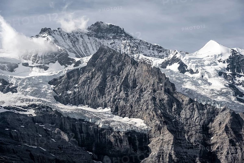 Snow covered mountain peaks Jungfrau and Silberhorn with glacier Jungfraufirn