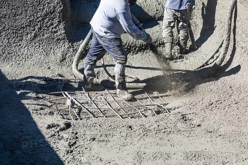 Pool construction worker shooting concrete