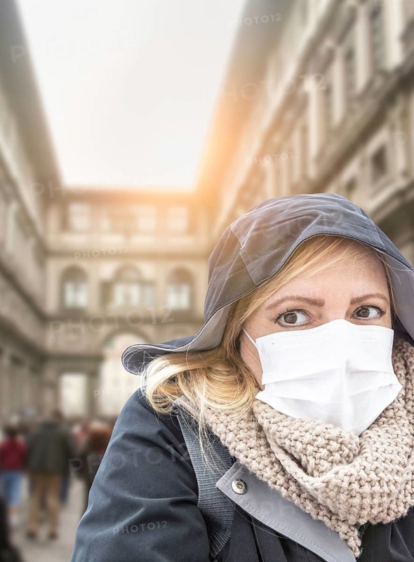 Young Woman Wearing Face Mask Walks Near the Uffizi Gallery