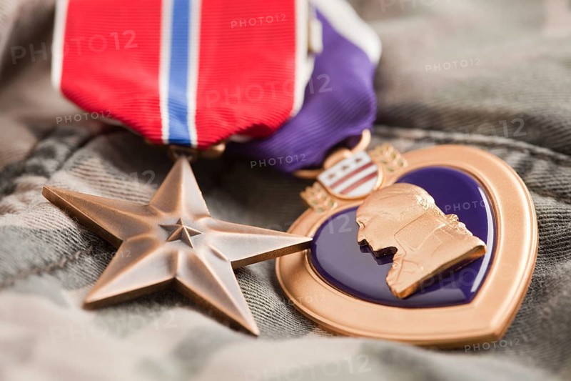 Bronze and purple heart medals on camouflage material