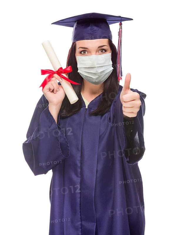 Graduating female wearing medical face mask and cap and gown give a thumbs up isolated on a white background