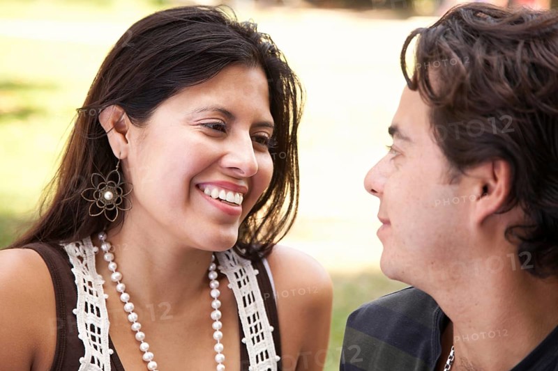 Happy attractive hispanic couple enjoying themselves at the park