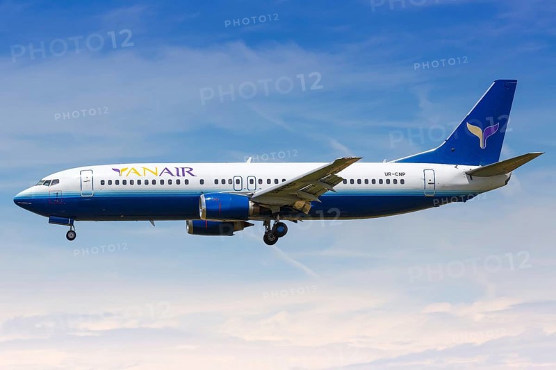 A YanAir Boeing 737-400 with the registration UR-CNP lands at Barcelona Airport