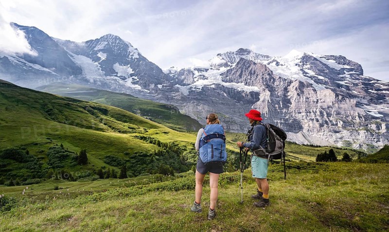 Two hikers in front of the Eiger north face