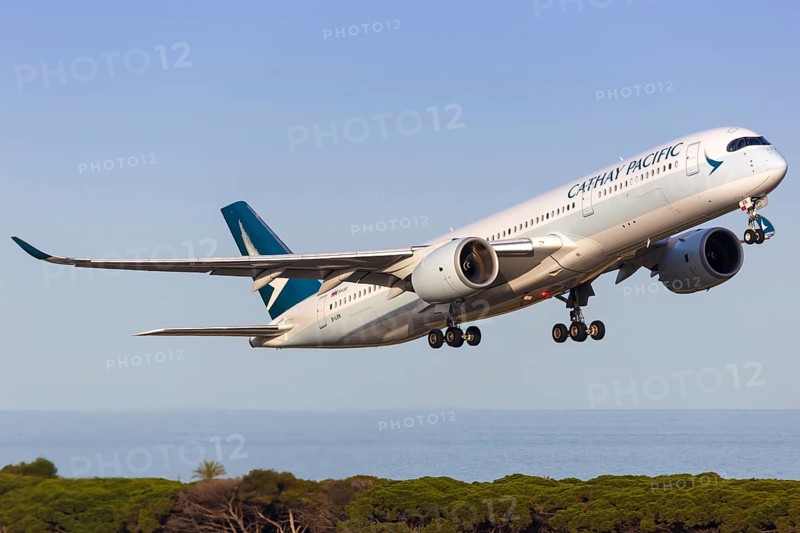 A Cathay Pacific Airbus A350-900 with registration B-LRN takes off from Barcelona Airport