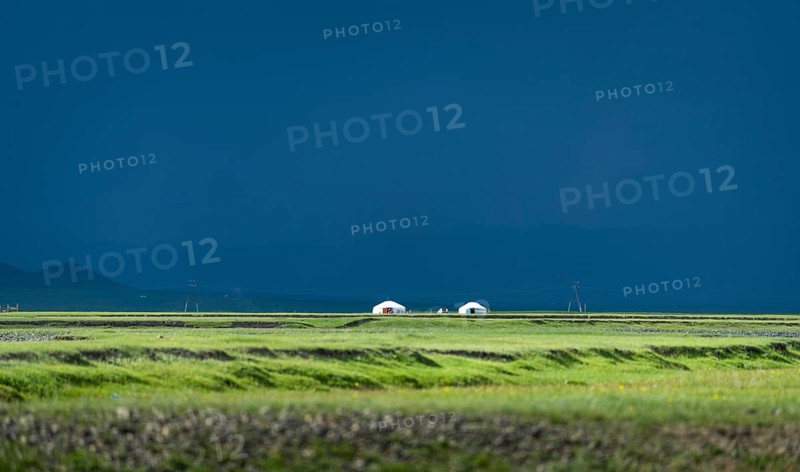 Outside a Mongolian nomad family in summer in front of the rain