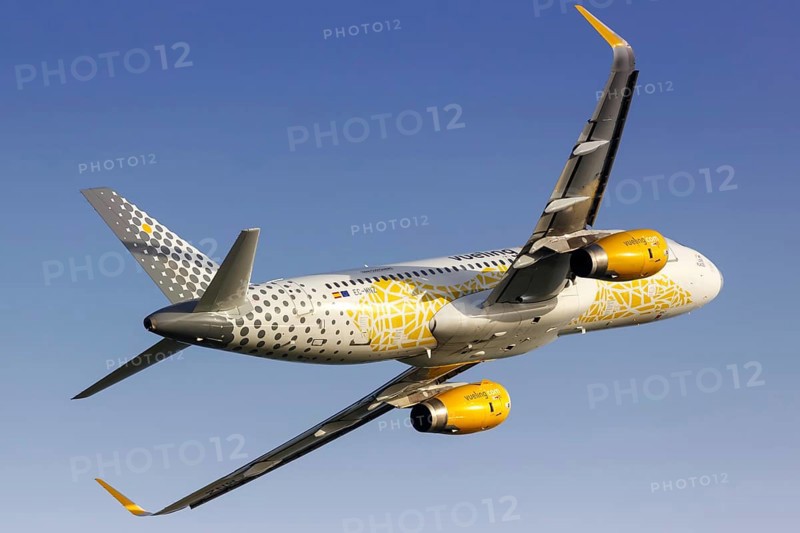 A Vueling Airbus A320 with the registration EC-MNZ and the Vueling Loves Barcelona special livery takes off from Barcelona Airport