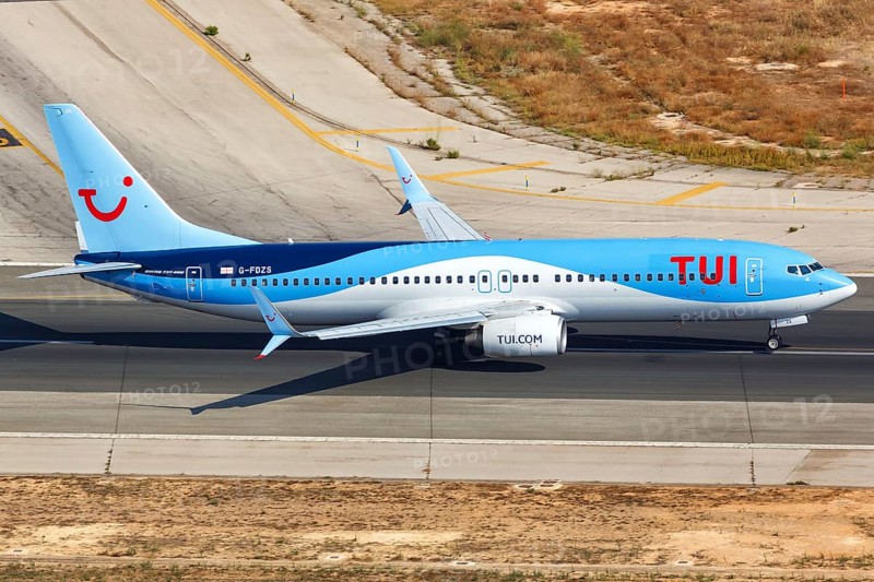 A TUI Boeing B737-800 with the registration G-FDZS takes off from the airport in Palma de Majorca
