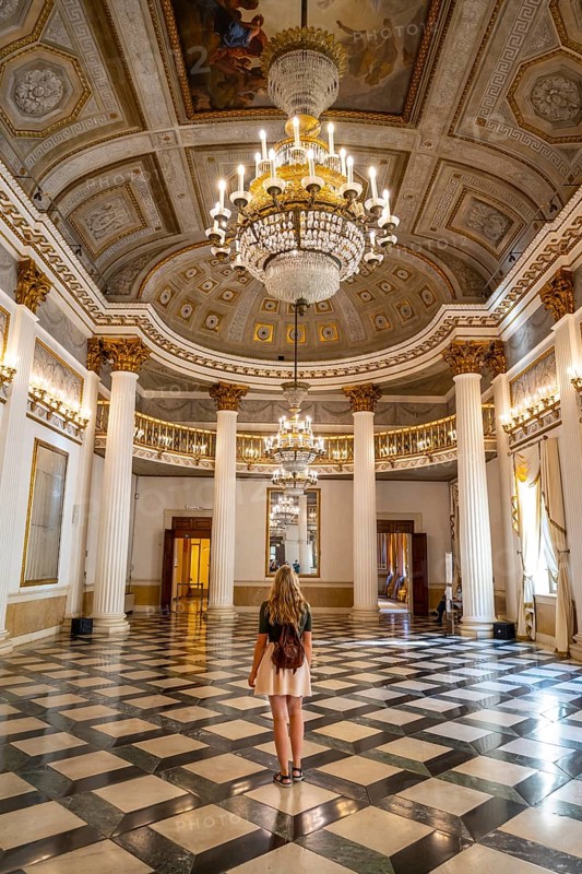 Young woman in a magnificent entrance hall
