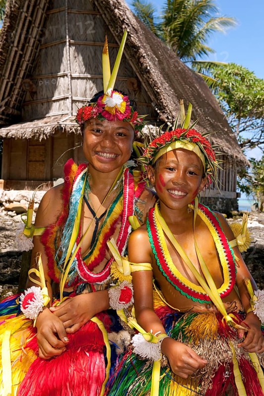 Girl and boy decorated for traditional bamboo dance