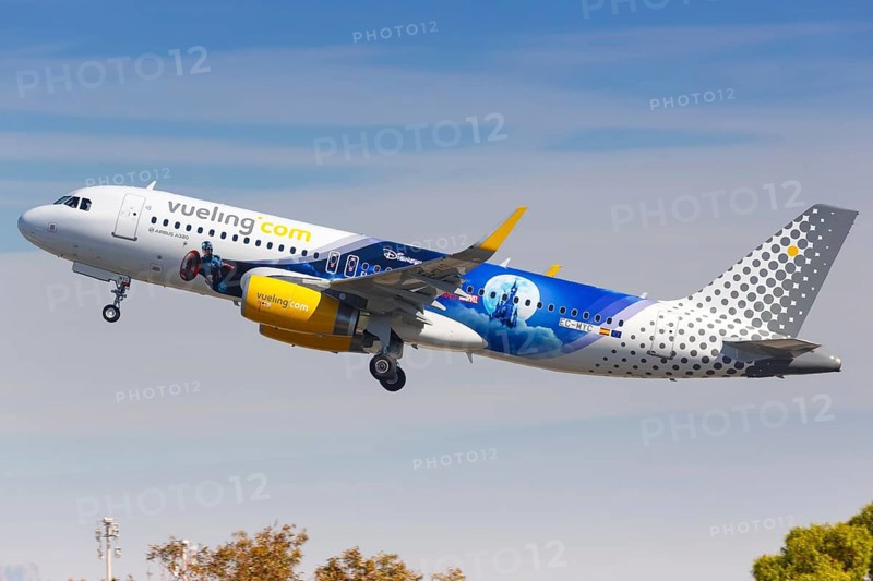 A Vueling Airbus A320 with the registration EC-MYC and the Disneyland Paris