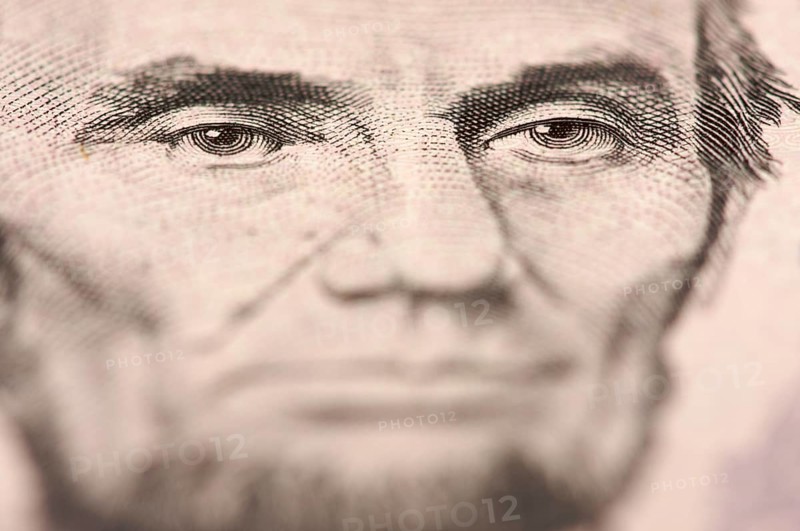 Abstract macro of U.S. five dollar bill's abraham lincoln face with narrow depth of field