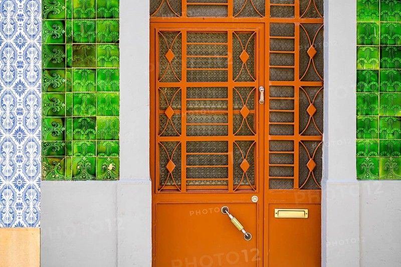 Metal doors to typical fisherman's house coverd with tiles called azulejo