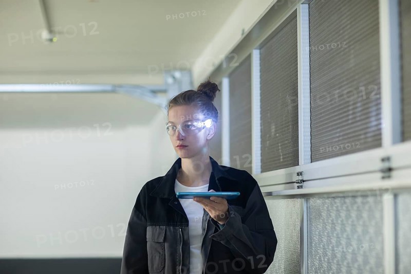 Young logistician working with scan glasses