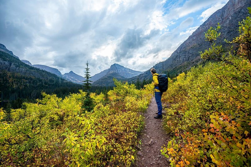 Hikers on a trail through mountain landscape