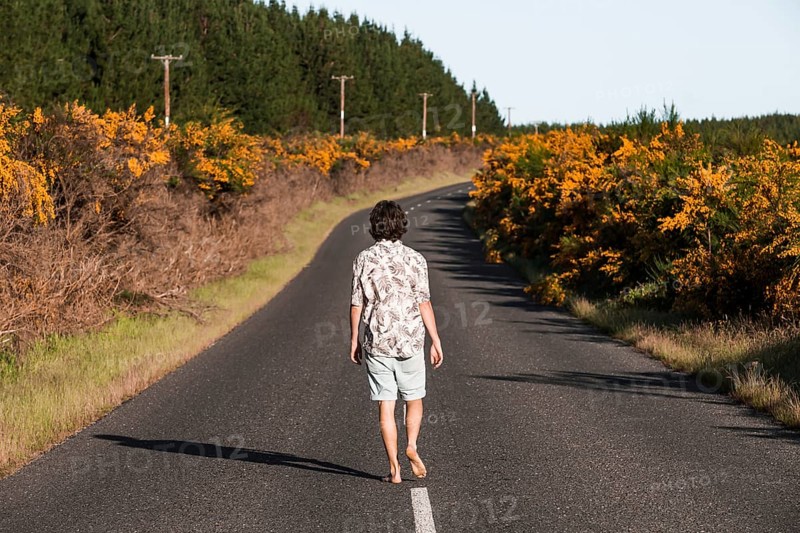 Guy walking on a road