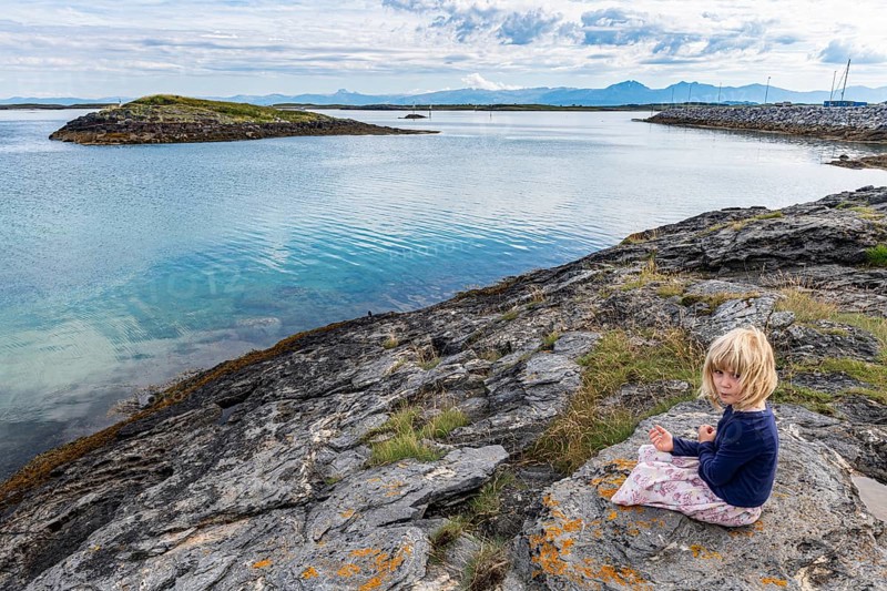 Little girl on a rock
