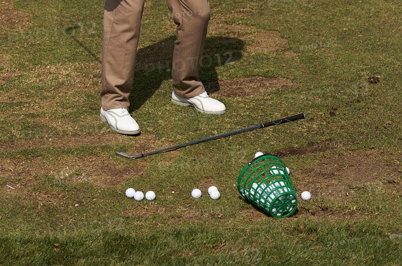 Golfer practicing his swing at the range