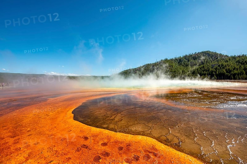 Steaming hot spring with colored mineral deposits