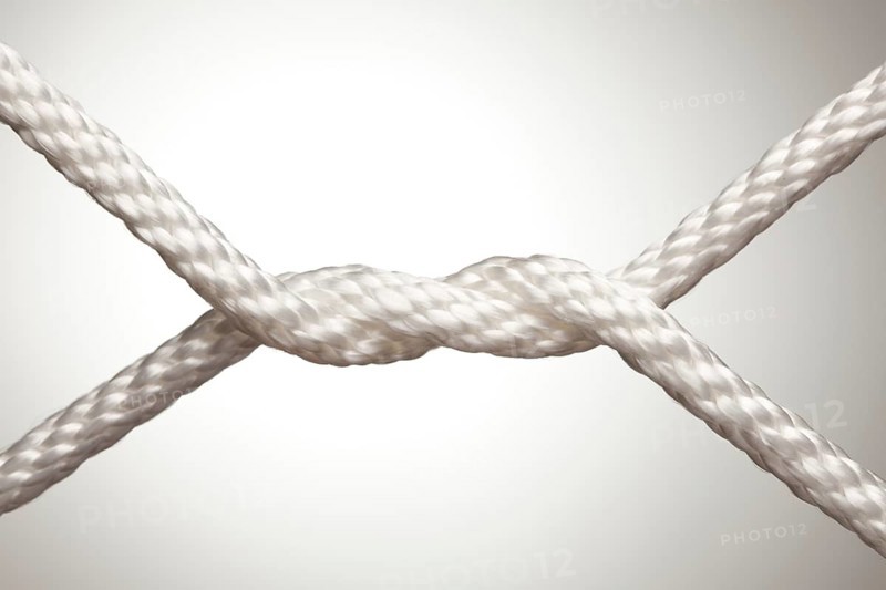 Nylon rope knot on a spot lit background