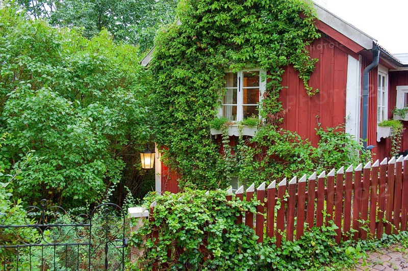 Red beranken Swedish house with picket fence wooden house in Vimmerby