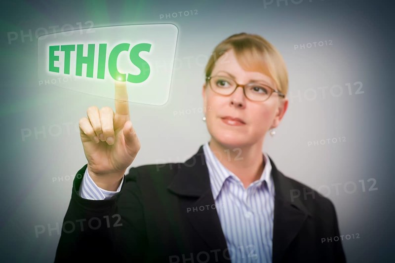 Attractive blonde woman pushing ethics button on an interactive touch screen
