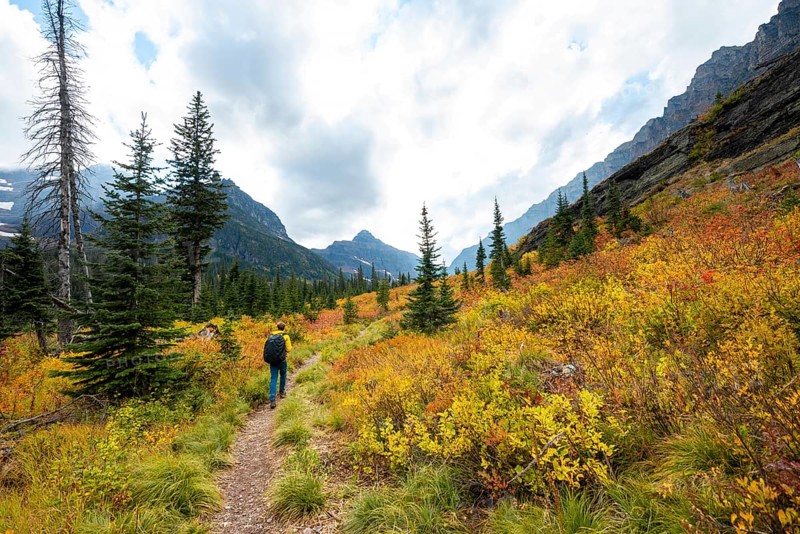 Hikers on a trail through mountain landscape