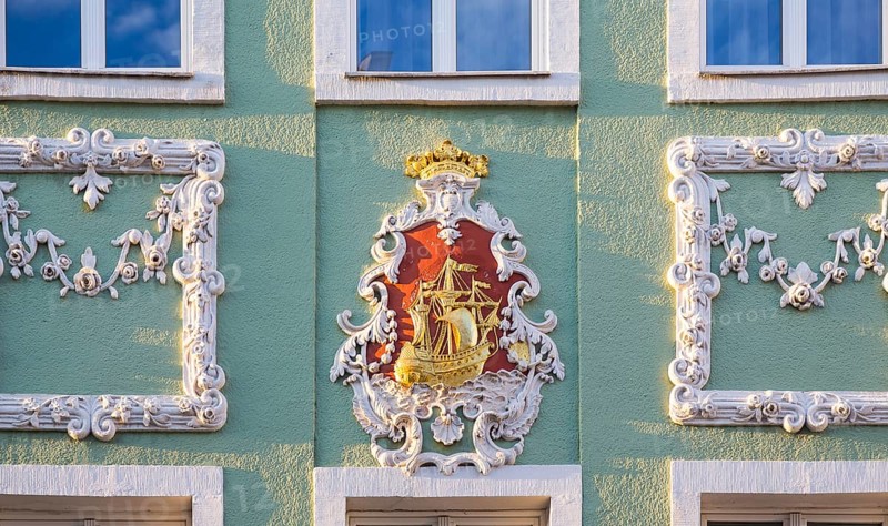 Stucco with sailing ship on a baroque facade of a residential house