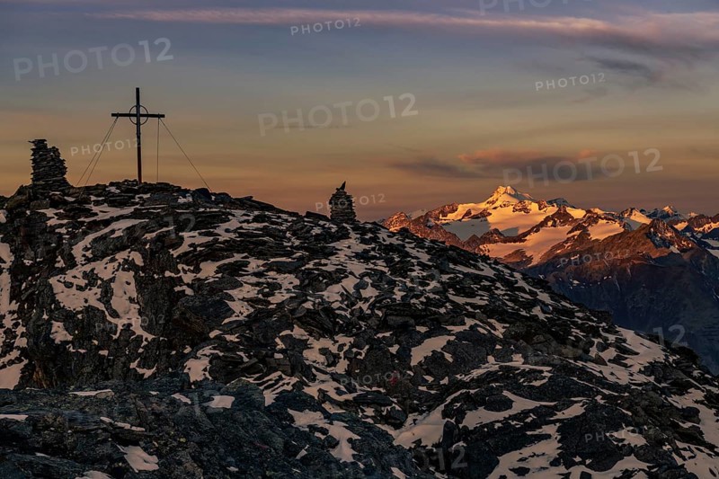 Sunrise over summit of the Oetztaler Wildspitze with summit cross of the high Nebelkogel