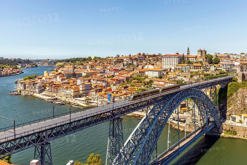 Beautiful panorama of city of Porto with metro on famous bridge