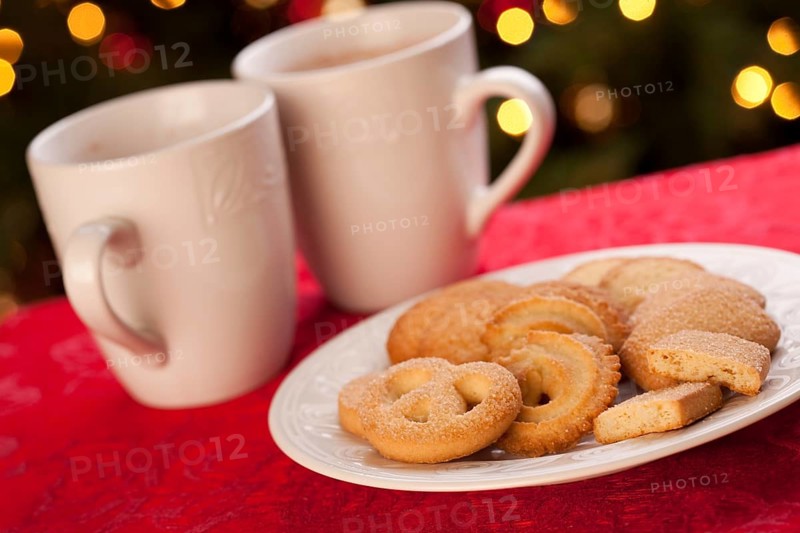 Hot chocolate and cookies in front of holiday lights