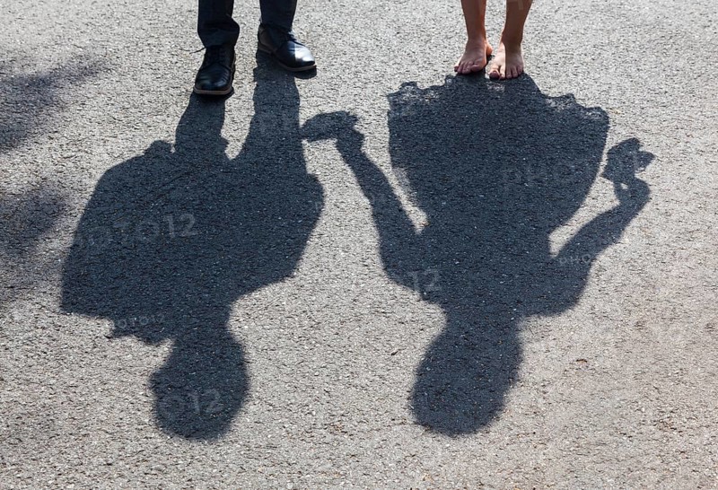 Shadow image of bride and groom on asphalt path