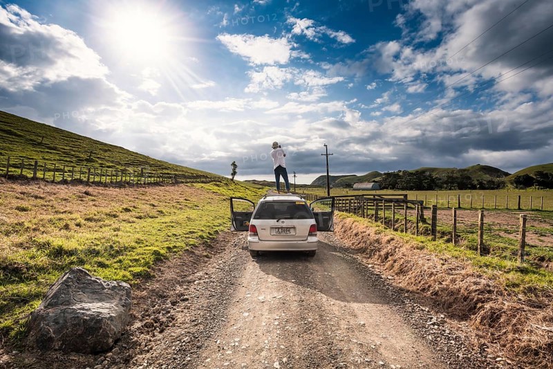 Guy on car roof with camera