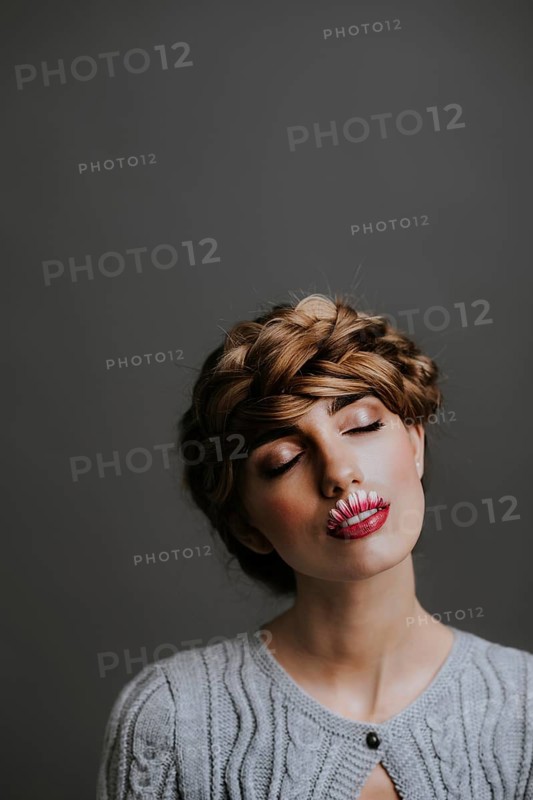 Young woman with flower lips