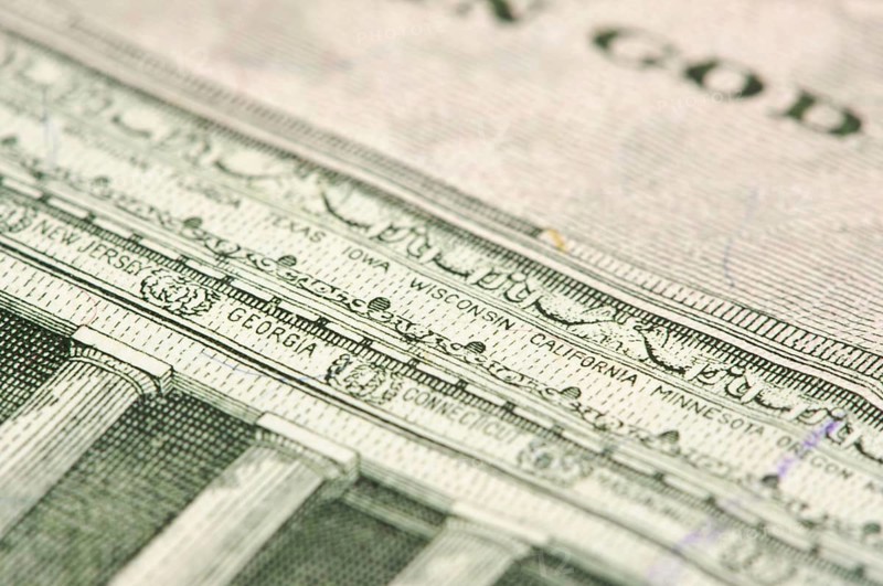 Macro of the back of the U.S. five dollar bill showing small state names as anti-counterfeit measure
