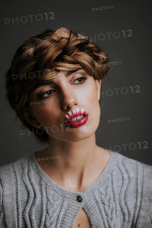 Young woman with flower lips