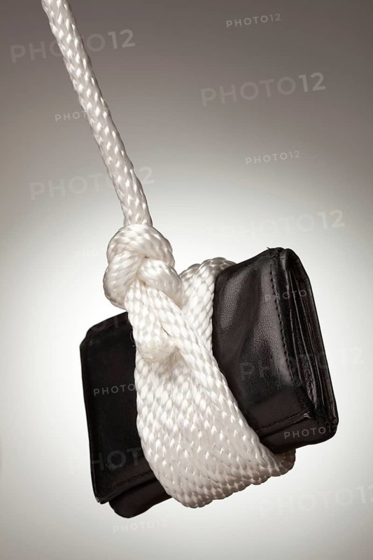 Tied up and hanging wallet on a spot lit background