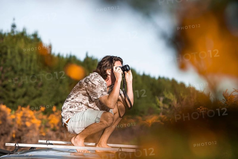 Guy with camera on car roof