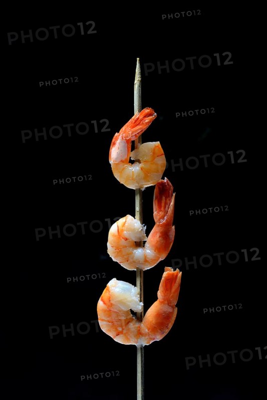 Cooked prawns on wooden skewer