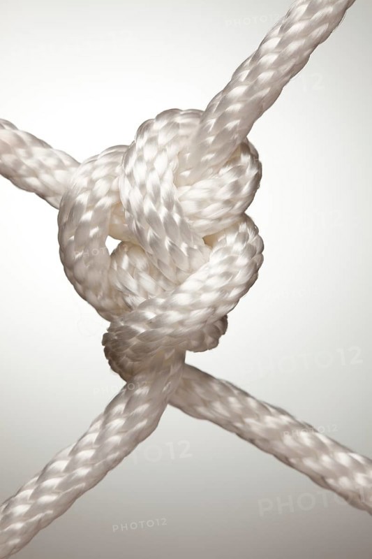 Nylon rope knot on a spot lit background