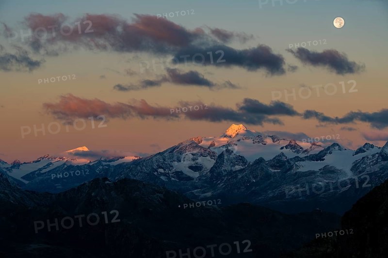 Full moon over summit of Oetztaler Wildspitze