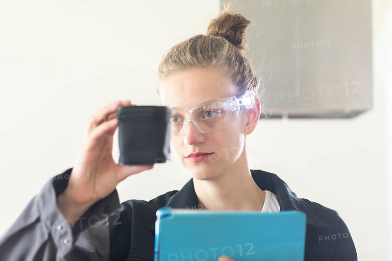 Young logistician working with scan glasses