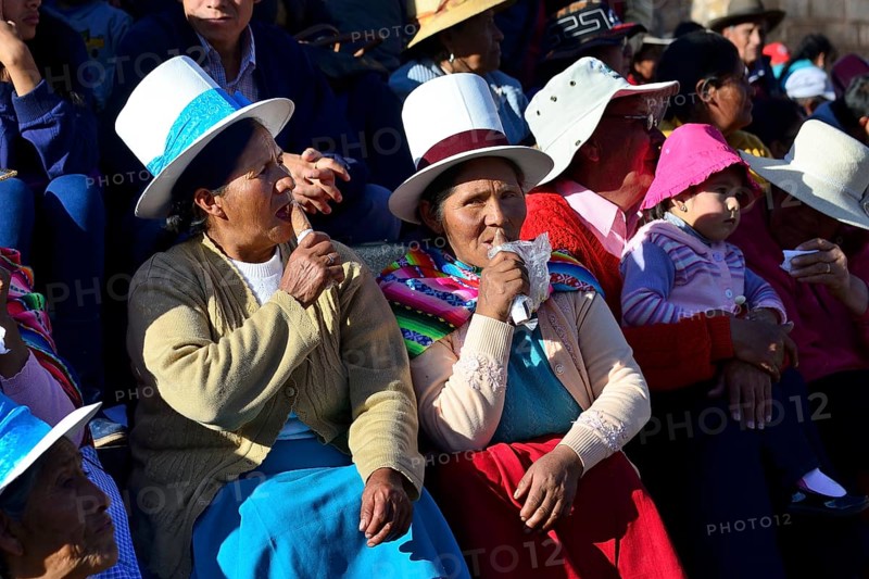 Two indigenous woman lapping up ice cream at the parade on the eve of Inti Raymi