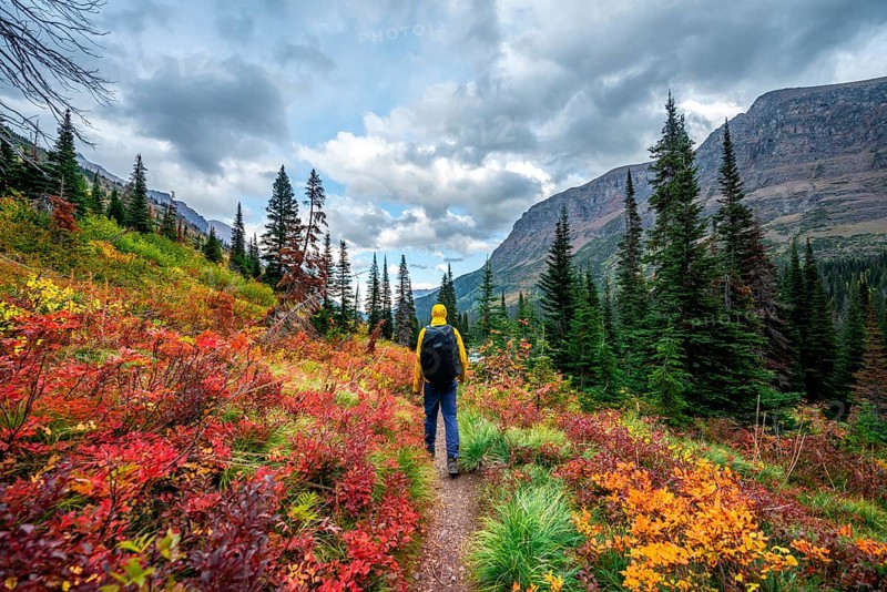 Hikers on a trail through mountain landscape