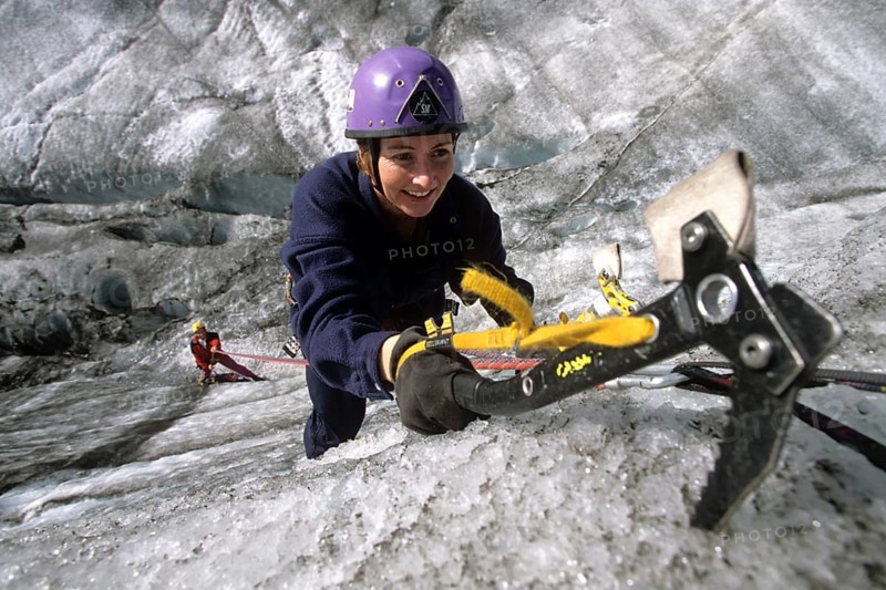 Woman with ice axe climbing