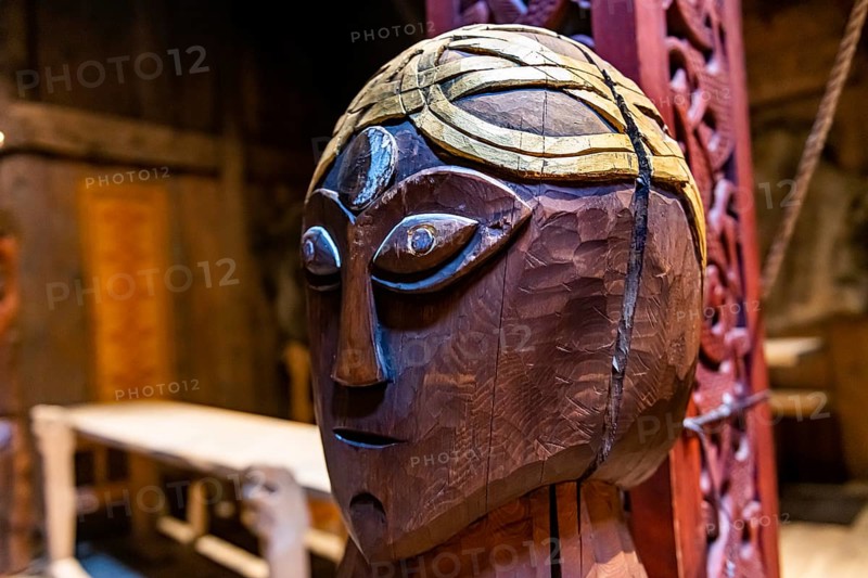 Wooden sculptures in a reconstructed long house in the Lofotr Viking Museum
